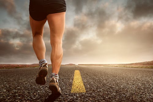 Runner running on an empty road